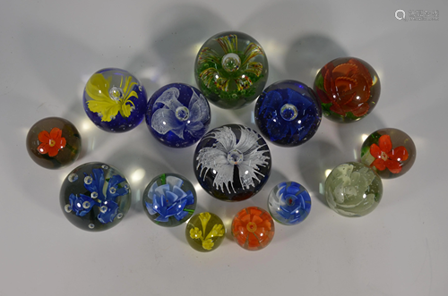 Fourteen various floral specimen paperweights