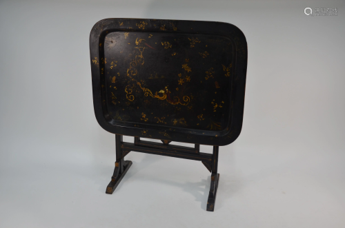 An antique black lacquer and gilt decorated til…