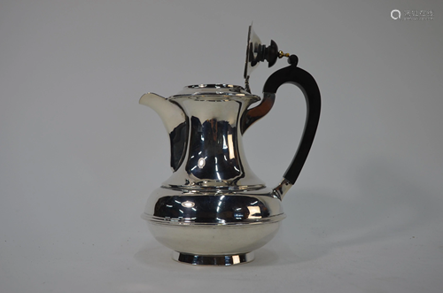 A silver hot water jug of baluster form