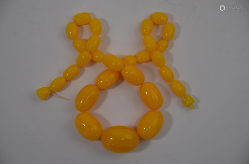 A row of graduated yellow amber beads