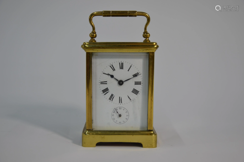 A small lacquered brass carriage travel alarm clock