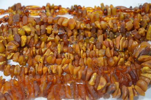 Four various rows of tumbled amber bead necklaces