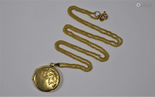 A circular yellow metal locket