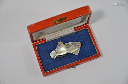 A mother-of-pearl tie slide in the form of a horse …