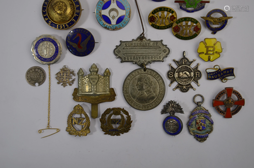 A collection of enamel and gilt metal badges