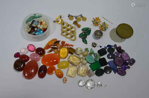 A tin of assorted loose gemstones