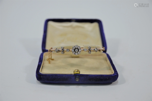 An early 20th century diamond set gold bangle