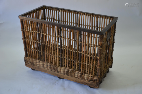 A vintage steel framed wicker and stick laundry trolley