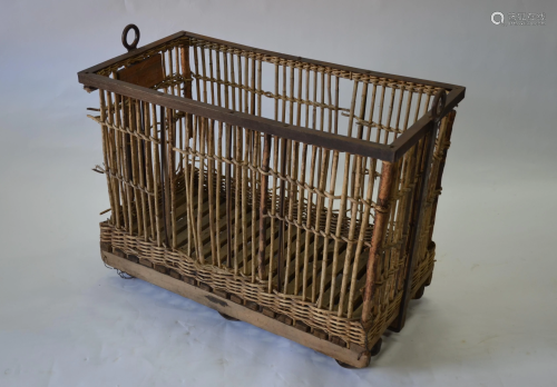 A vintage steel framed wicker and stick laundry trolley