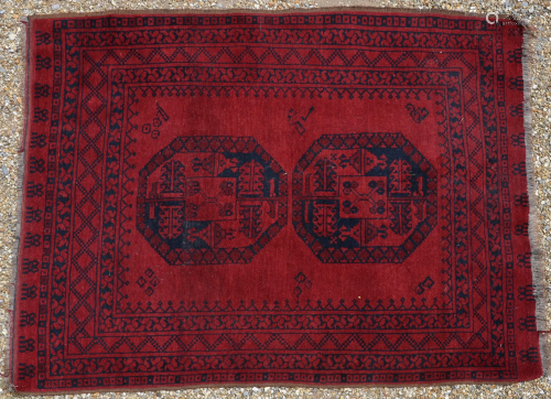 An old Afghan red ground rug