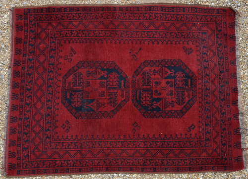 An old Afghan red ground rug