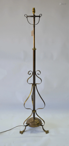 An Arts & Crafts brass tripod standard lamp