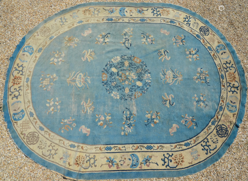 An antique Chinese blue ground oval rug