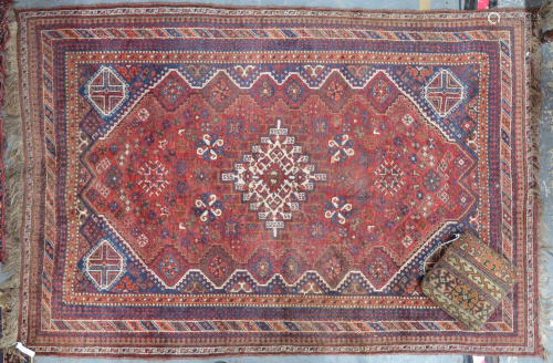 An old Persian Shiraz rug and an old carpet cushi…