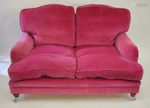 A contemporary dark pink upholstered Howard style…