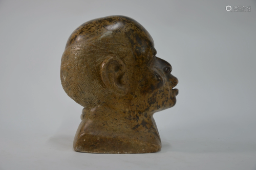 An African carved stone head sculpture