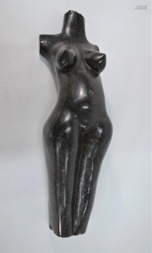 A polished stone sculpture - a female torso