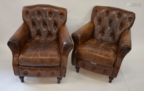 Pair of antique battered brown leather armchairs