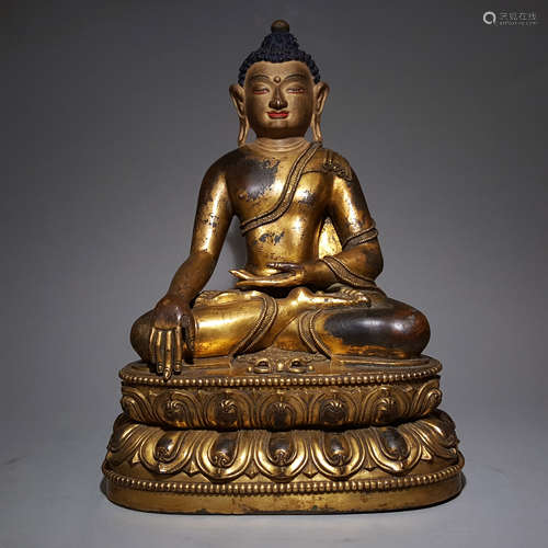 A MING DYNASTY BRONZE GILDED ORIENTAL IMMOVABLE BUDDHA