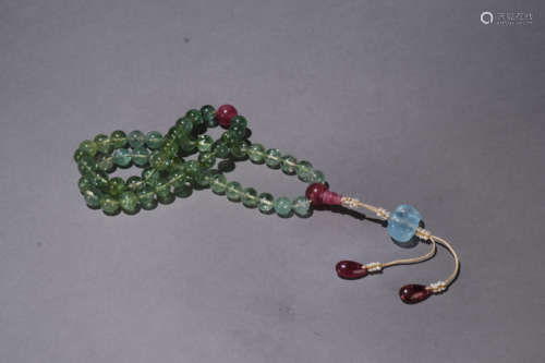 A QING DYNASTY TOURMALINE HAND STRING