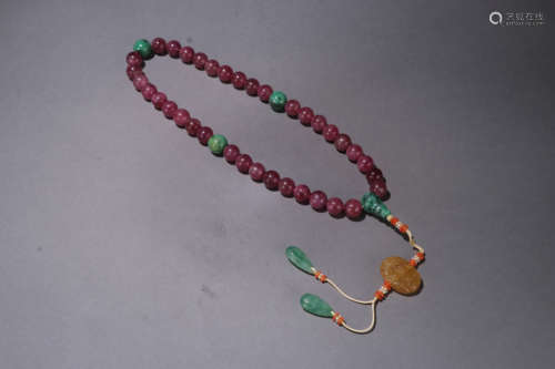 A QING DYNASTY TOURMALINE THIRTY SIX SEADS HAND STRING