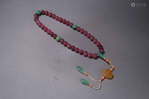A QING DYNASTY TOURMALINE THIRTY SIX SEADS HAND STRING