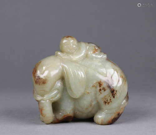 A QING DYNASTY HETIAN JADE BOY PLAYING WITH AN ELEPHANT