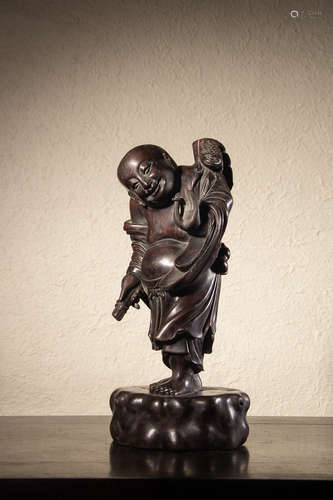 A Chinese Hardwood Carved Boy Liuhai