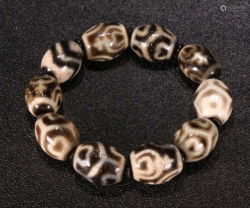 A DZI STRING BRACELET WITH 10 BEADS