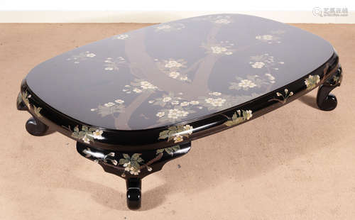 A WOOD TABLE WITH FLOWER PATTERN