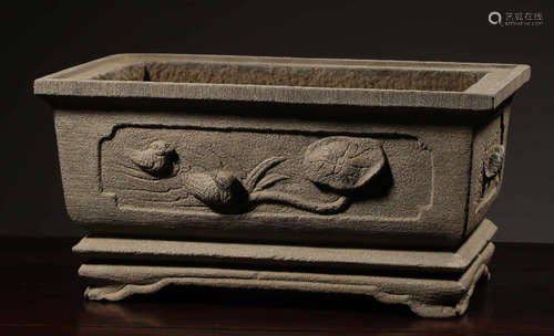 A STONE CONTAINER CARVED WITH BIRD