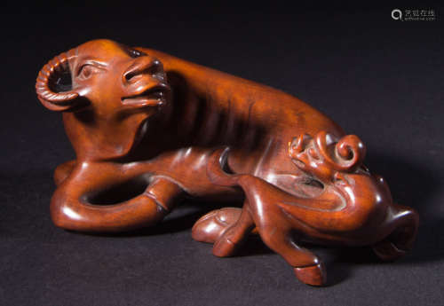 A HUANGYANG WOOD PAPERWEIGHT SHAPED WITH BEAST