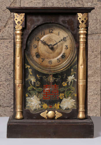 A CLOCK WITH WOOD FRAME