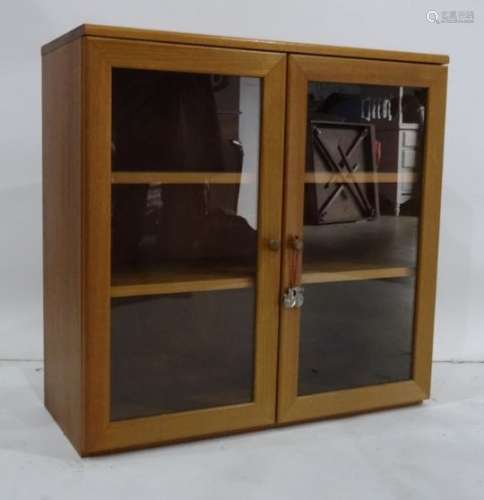 Teak two-door cabinet with two glazed doors enclosing shelves, 75 x 72cm