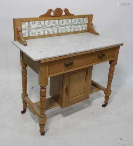 19th century pine washstand with tiled back, white marble tops, single drawer above a cupboard door,