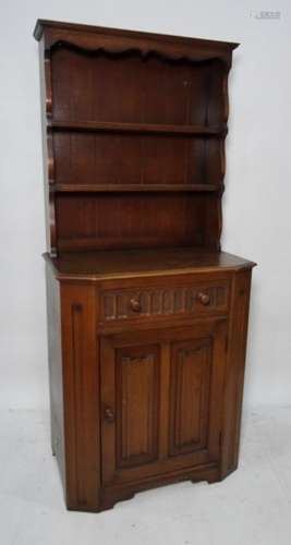 20th century dresser, the top with open shelves above base of single drawer and cupboard and door,