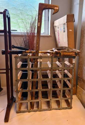 Wine rack, riding crop, a vintage tennis racket, etc.