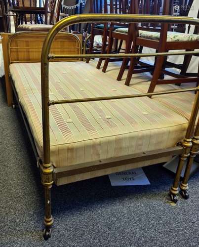 Pair of tubular brass framed beds by Maples, raised on castors, bearing ivorine plaques