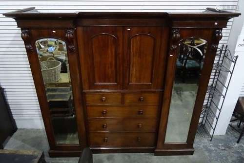 Victorian mahogany breakfront wardrobe compactum, the moulded cornice above two central arched