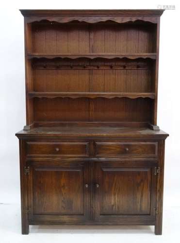 20th century oak dresser, the moulded cornice above open shelves, a base of two drawers and two