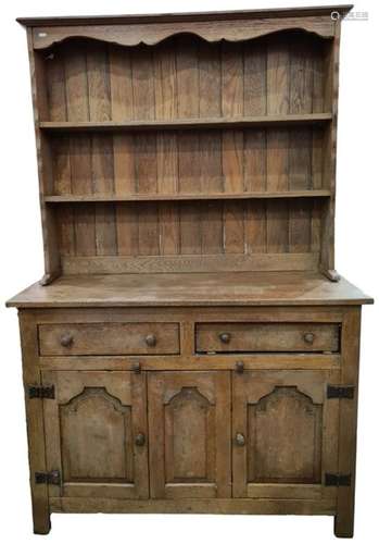 20th century oak dresser, with open shelves above two drawers and three cupboard doors, raised on