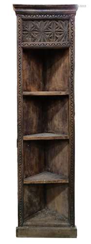 African-style corner shelving unit with heavily carved decoration, on plinth base, 183cm high