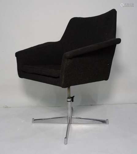 Mid-20th century black weave tub chair on chrome swivel supports to quatrefoil base