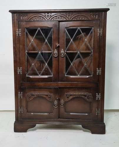 20th century oak corner cupboard with leaded glazed doors above two cupboard doors, bracket feet