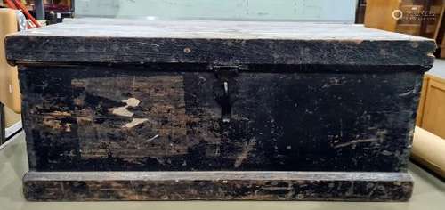 Early 20th century black painted pine trunk with iron hasp and some shipping labels