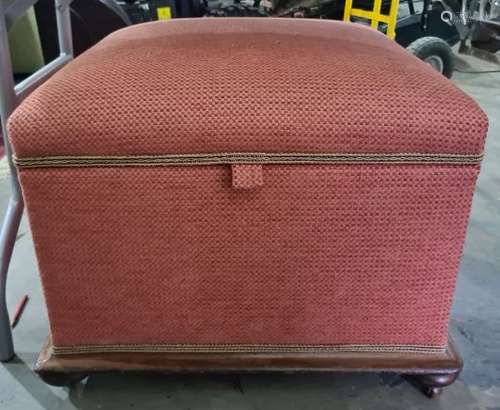 Late 19th century ottoman in pink ground upholstery, mahogany base on squat bun feet and castors