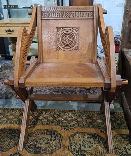 Reproduction oak Glastonbury type chair with carved decoration