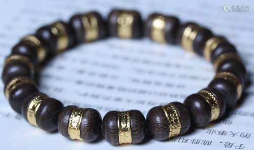 AN INDONESIA CHENXIANG WOOD WITH 14K GOLD BRACELET