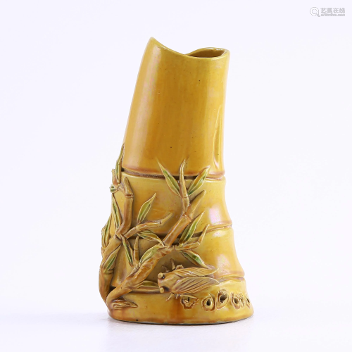 Yellow-glazed flower arrangement with bamboo kn…