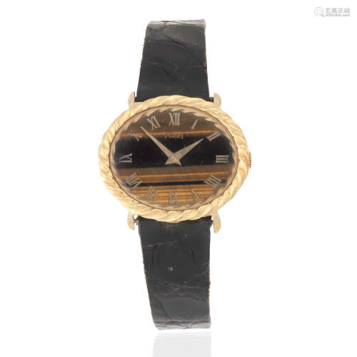 Piaget. A lady's 18K gold manual wind oval wristwatch with tiger's eye dial Ref: 9803, Circa 1980